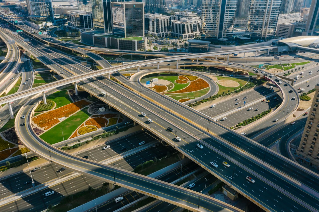 Aerial view of a bustling urban highway interchange amidst skyscrapers and modern architecture.